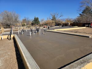 Custom concrete foundation with colored concrete and smooth finish and stem walls with insulation and radon protection in Albuquerque, NM