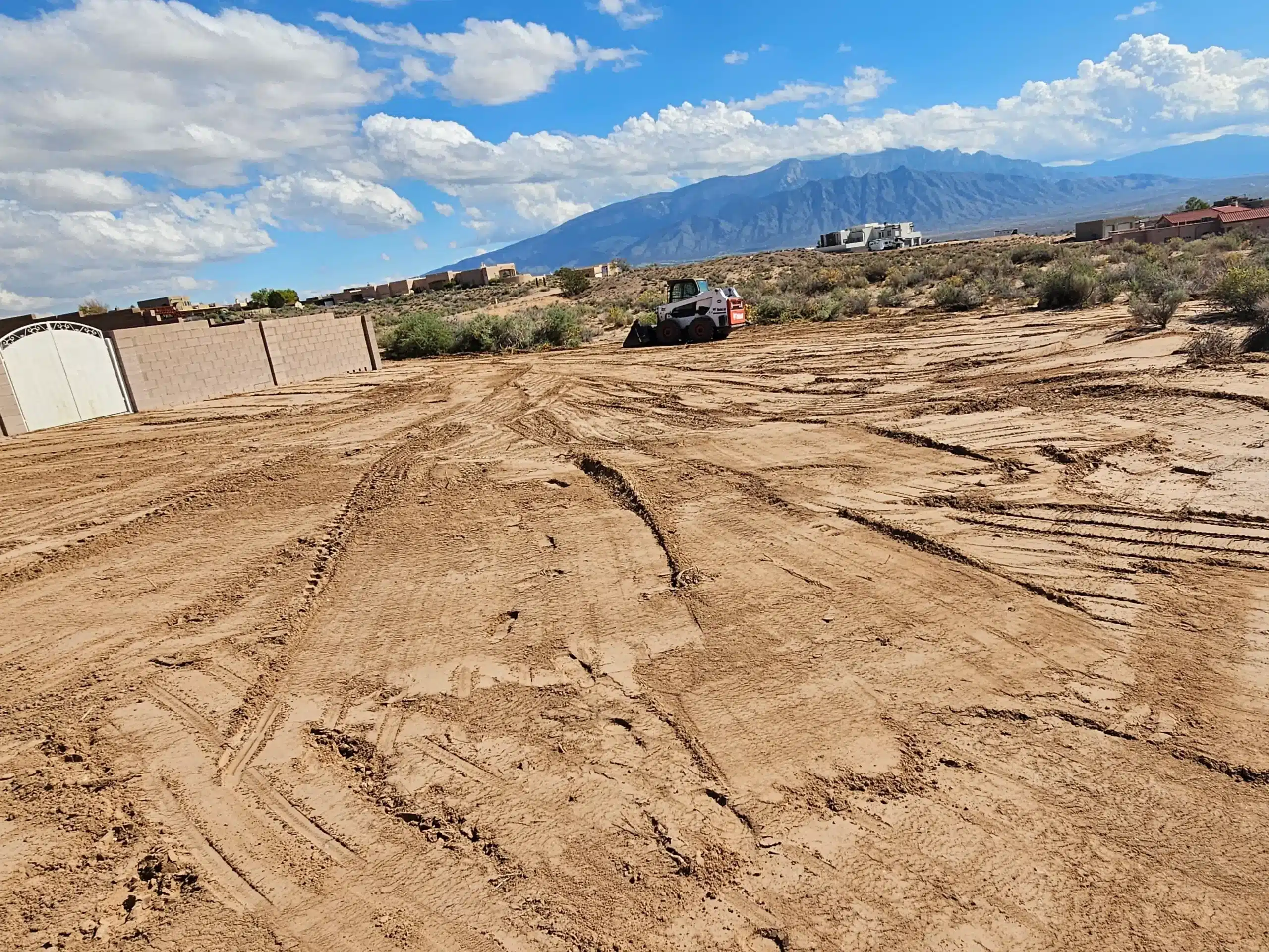 Professional Bobcat and Backhoe services in Albuquerque, showing heavy equipment for site preparation and grading.