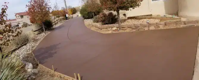 ​"Large 5,000 sq ft colored concrete driveway installed by M&M Concrete in North Albuquerque Acres."