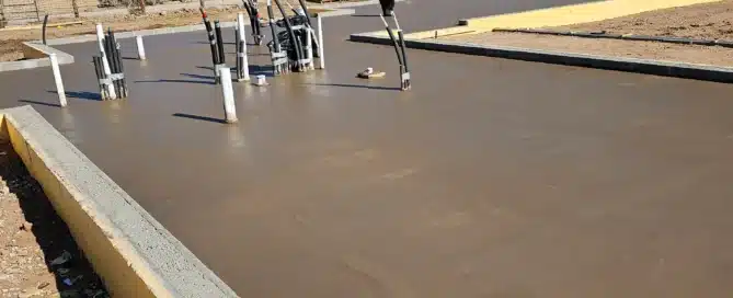 Custom colored concrete foundation poured for a luxury home in Santa Fe by M&M Concrete.