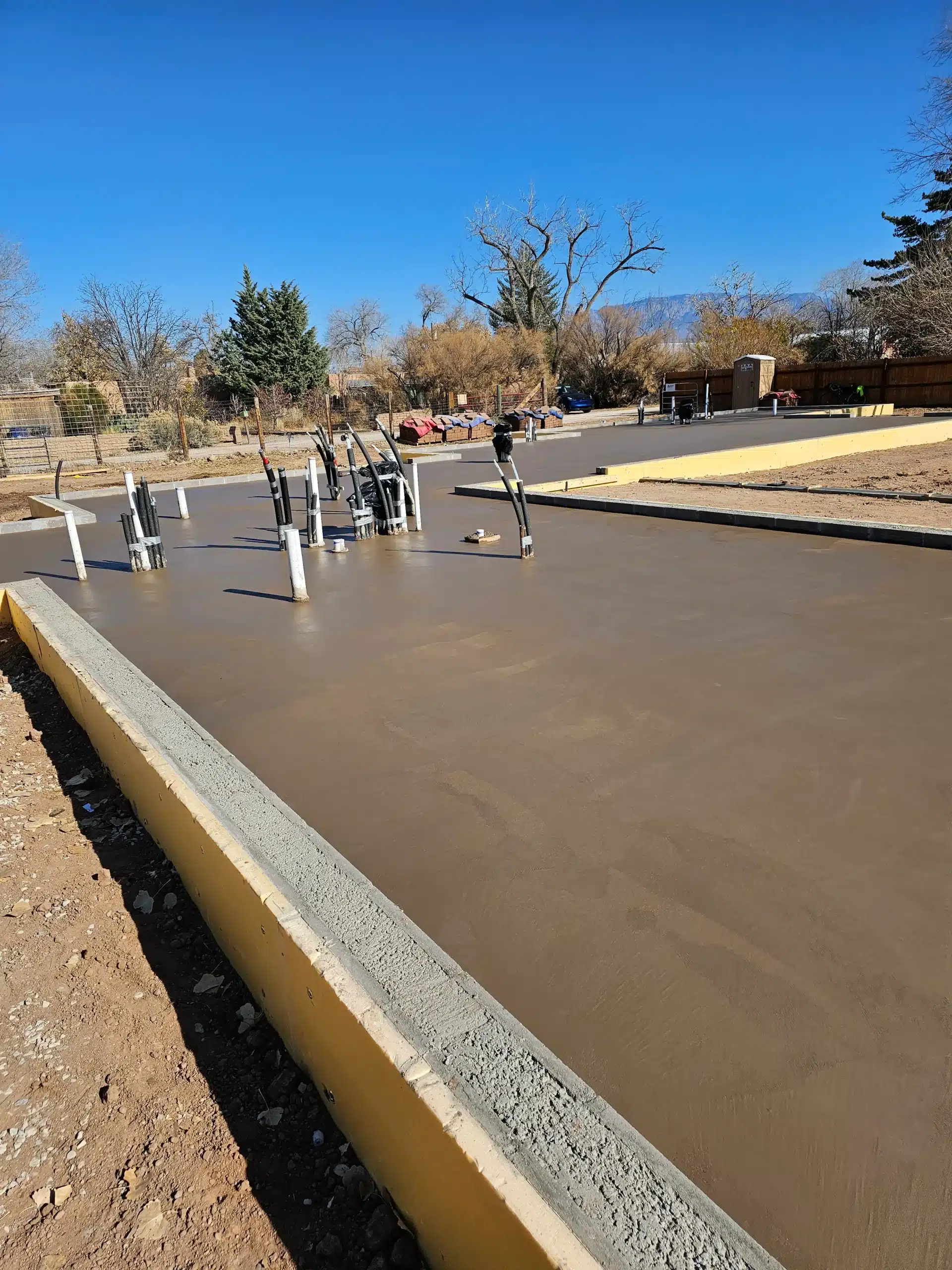 Custom colored concrete foundation poured for a luxury home in Santa Fe by M&M Concrete.
