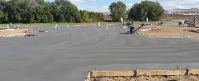 Monolithic concrete slab foundation for an 8000 sq ft custom home in Albuquerque South Valley, featuring subgrade preparation for an integrated 3000 sq ft stamped flagstone concrete patio.