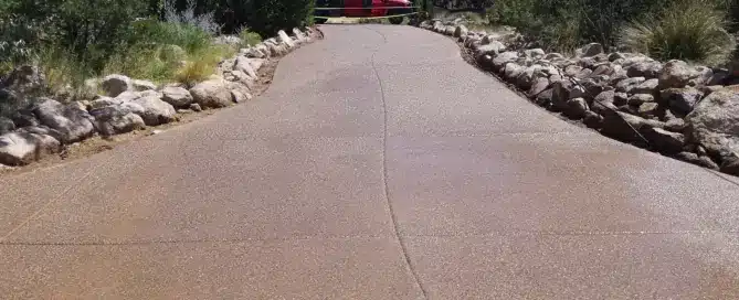 6500 sq ft colored exposed aggregate concrete driveway in Sandia Foothills Albuquerque NM — installed by M&M Concrete with boulder removal and in-house excavation 505 550 0418 M&M Concrete