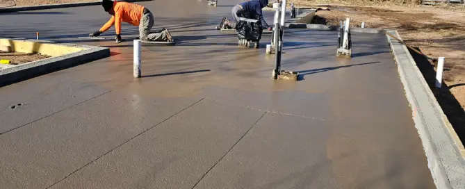 Santa Fe concrete contractors M&M Concrete — 4500 sq ft colored concrete foundation with stem wall, radiant heating, vapor barrier and crew finishing the slab